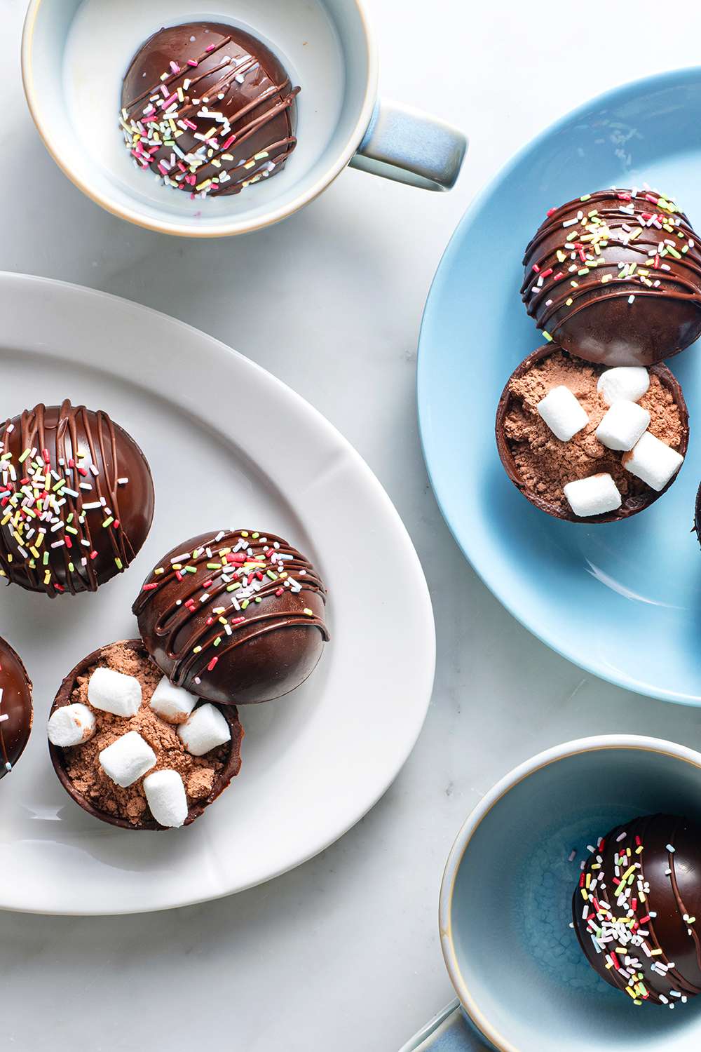 Hot Chocolate Bombs in a cups and on platters