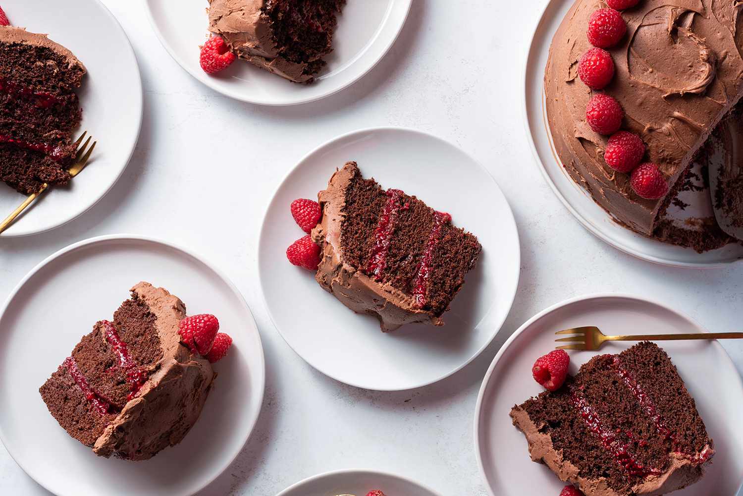 Chocolate Raspberry Layer Cake on a platter and cake slices on plates